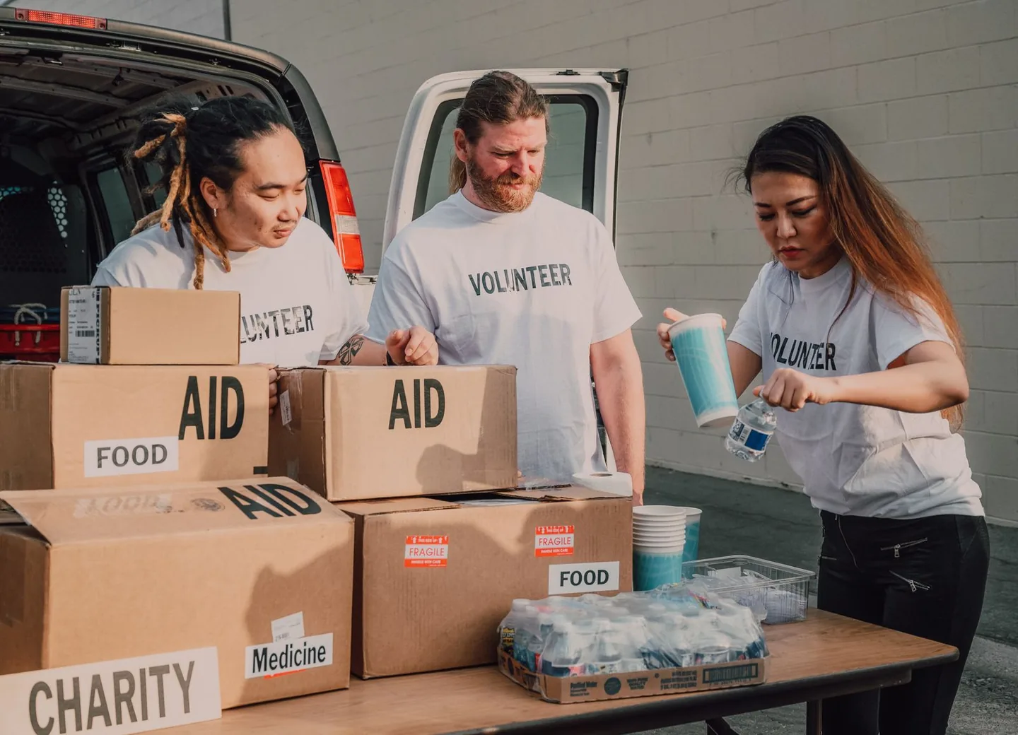Volunteers sorting boxes of donated food and aid supplies